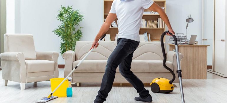 Man doing five cleaning chores at a time.